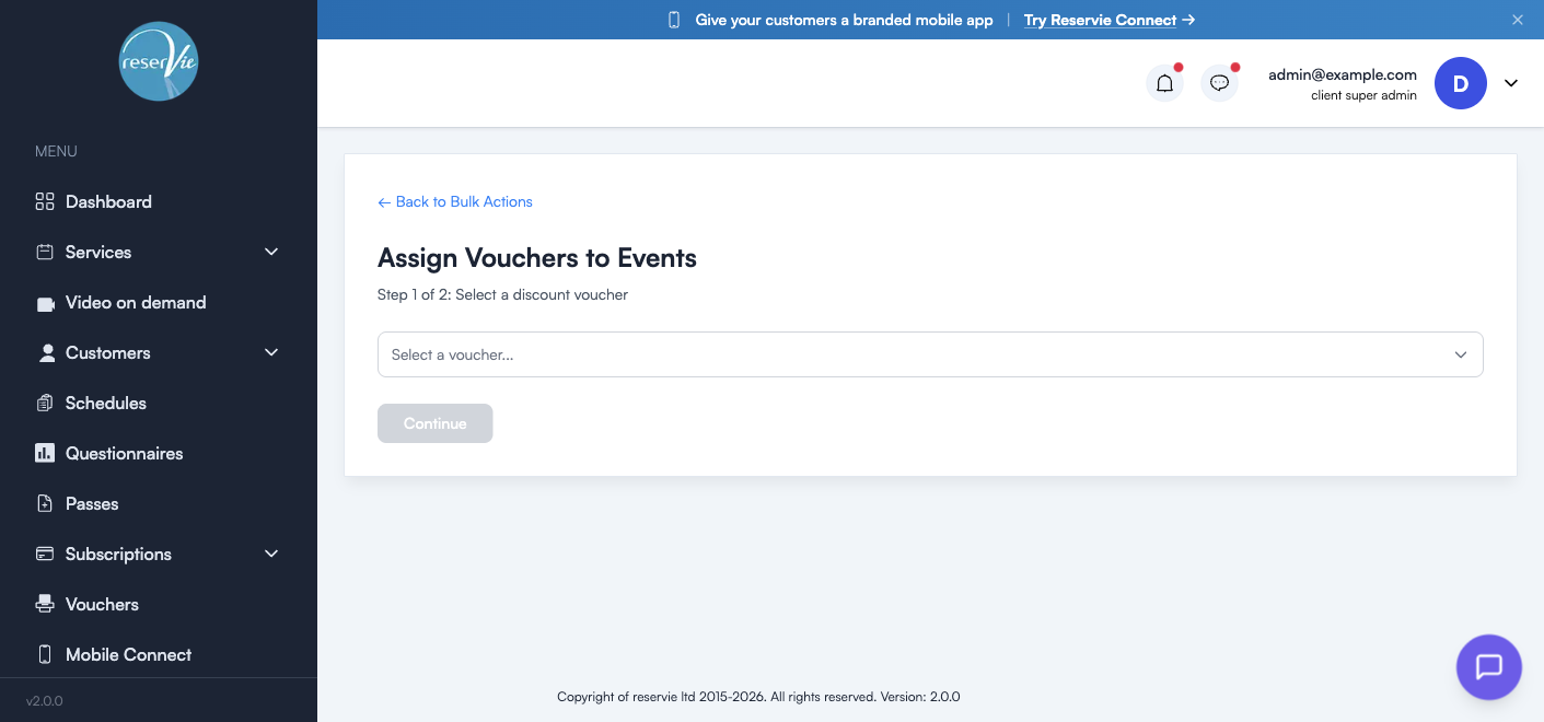 Step 1 of Assign Vouchers showing the voucher dropdown and a disabled Continue button until a voucher is selected